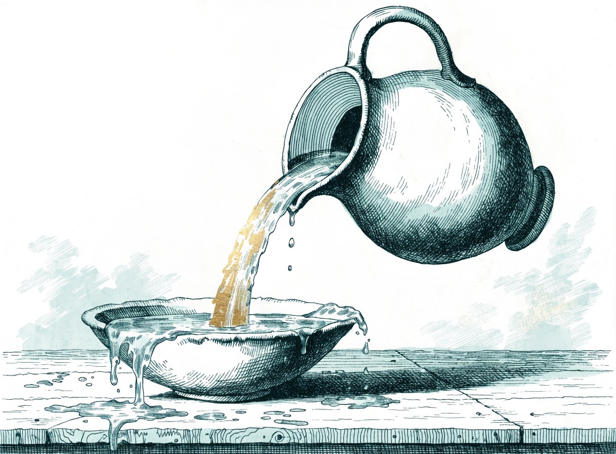 A clay pitcher pouring a full gold stream into a bowl that overflows onto the table